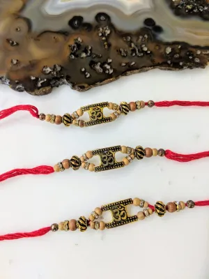 (Set of 3) Golden Rakhi with OM Design Tulsi Beads Red Thread Rakhi